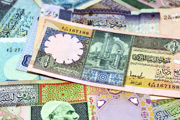 Background of Libyan money dinars banknotes, Old Libyan money banknotes, Libyan Dinar is the currency of Libya , selective focus of different banknotes from Libya of different values and years - obrazy, fototapety, plakaty