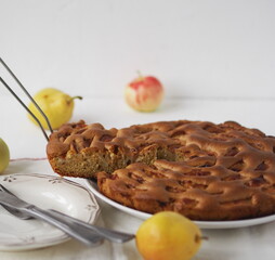 A cut piece from a summer round apple pie or muffin on an ancient ancient table. Homemade baking.