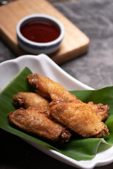 Fried chicken wings in a white cup. The view from the top. Space for text.