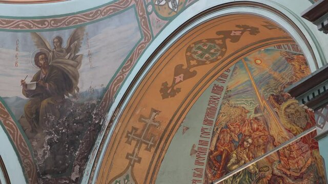 The dome of an old Christian Orthodox church in the center of Russia. Frescoes and walls painted with icons.