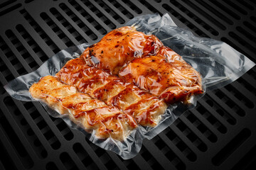 Vacuum-packed grilled meat, on a dark background. Set of different types of meat. Ready to eat.
