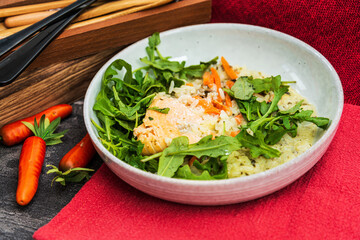 Fresh and tasty tartare of raw salmon prepared with salmons eggs and vegetables on top served in white plate