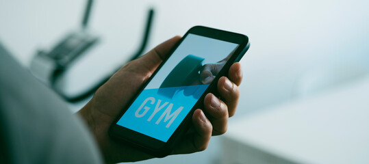 man and text gym in his smartphone, web banner