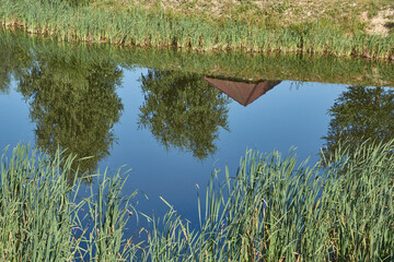 Fishing on the lake. Reflection in water. Recreation center. August 2021.