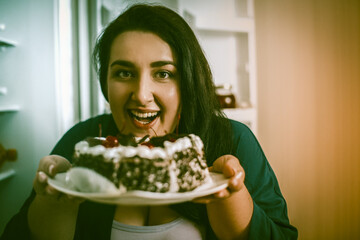 Body Positive Woman Going To Eat Dessert, Highlighted Focus On Female Smiling Face Looking At Camera, Portrait Of Plus Size Model Holding Plate With Chocolate Cake With Cherries In Foreground