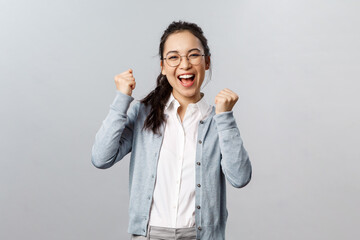 Super cool news, good for you. Optimistic, supportive asian girl encourage friend, watching sports...