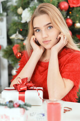 Portrait of happy teenage girl sitting with gift