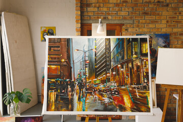 Modern abstract oil painting on canvas sitting on easel in artists studio