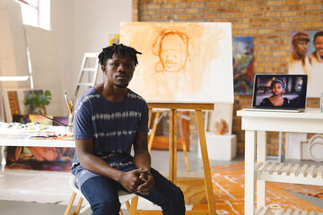 Portrait of african american male painter at work looking at camera in art studio