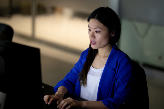 Asian businesswoman working at night using computer