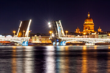 Fototapeta na wymiar Open Annunciation (Blagoveshchensky) bridge and St. Isaac's cathedral dome at night, Saint Petersburg, Russia