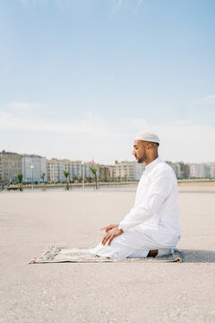 Muslim man praying on beach