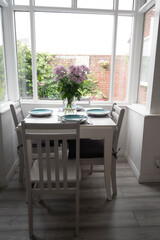 Bishop, Auckland, U.K. 27 July, 2021. Beautiful dinning room withwhite table, chair and lovely flowers.