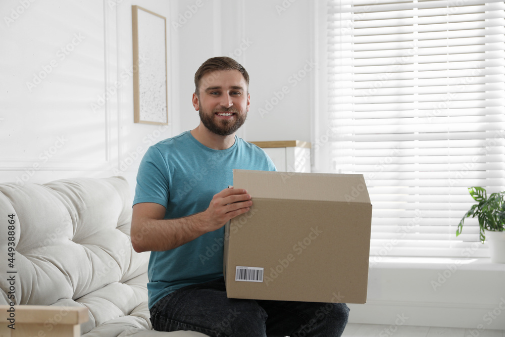 Canvas Prints Happy young man with parcel at home