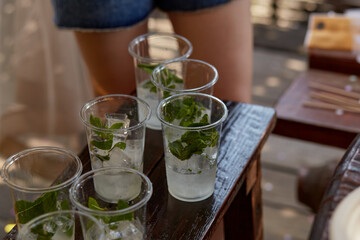 Young woman at a bachelorette party makes a mojito cocktail for the company. Preparation instructions. Step 3
