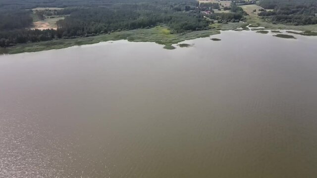 A bird's-eye view of the Siemianówka dam reservoir in the upper Narew valley.A bird's-eye view of two water pools separted track connected by a bridge. 