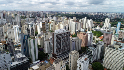 Fototapeta na wymiar Aerial view of the Jardim Paulista region. Many housing buildings. With Av. 9 de Julho and Ibirapuera Parque in the background