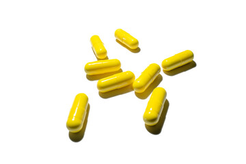 yellow capsules on the white background