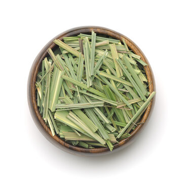 Top view of dried lemongrass herb in wooden bowl