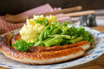 German thuringian bratwurst with mashed potatoes and vegetables
