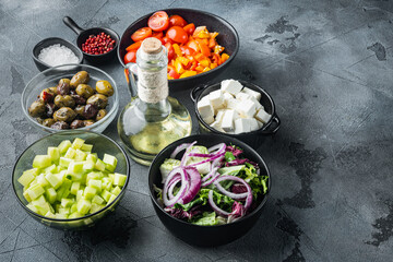 Greek salad main ingredients: fresh olives mix, feta cheese, tomatoes, pepper, on gray background ...