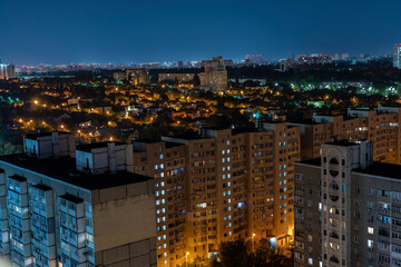 Obraz premium Night cityscape, lights from the windows of houses, stars in the sky, sleeping area. High quality photo