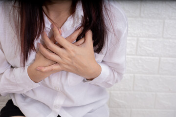 Asian female suffering from severe chest pain