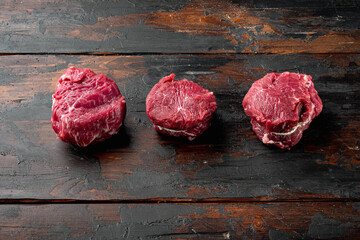 Raw fresh marbled meat Steak filet mignon , on old dark  wooden table background, with copy space...