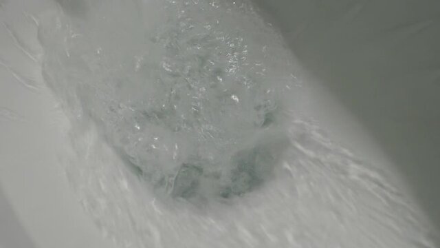 Flushing water down the toilet slow motion