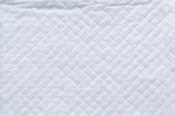 closeup white and soft baby cloth crumpled diapers or disposable flat bed sheet with square...
