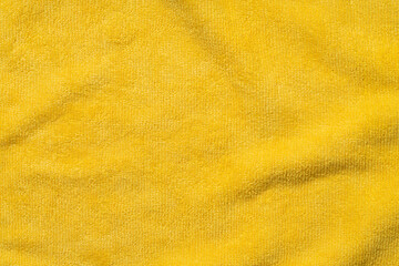 Clothing fabric yellow texture background, close up of cloth textile surface abstract.