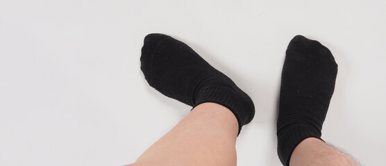 Asian leg and foot wear black sock on white background. isolated