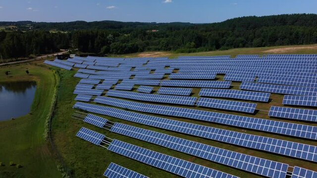 An aerial footage of a field with rows of solar batteries