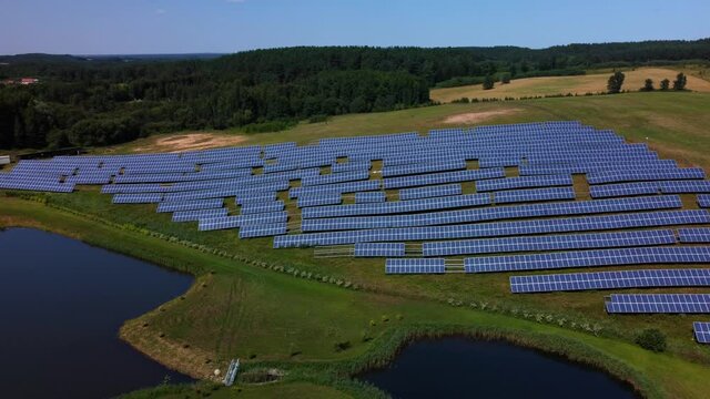 An aerial footage of a field with rows of solar batteries