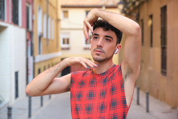 Portrait of a young caucasian man with long false nails posing.