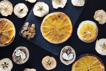  Mixed nuts and dried fruits on a slate dish on a dark background, top view, banner. Healthy snack-a mixture of organic nuts and dried fruits