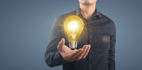 Hand of holding illuminated light bulb,  innovation inspiration concept