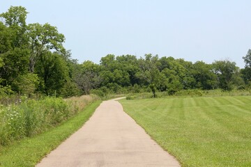 The long empty pathway in the countryside park.
