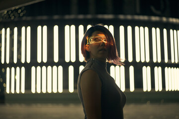 Cyberpunk style portrait of beautiful young woman in futuristic costume.