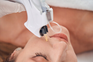 Joyful woman doing beauty injections for face