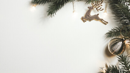Christmas decorations, light, reindeer, balls and branches on a white background for the concept of holidays and festival celebrations