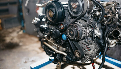 Fototapeta premium engine removed from the car, engine repair, replacement of drive belts, rollers, chains.