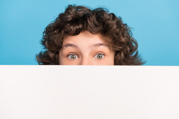 Photo of adorable impressed schoolboy wear white shirt billboard cover mouth isolated blue color background