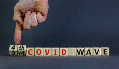 Symbol for a fourth wave of the covid-19 corona virus. Doctors turns cubes, changes words 3rd covid...