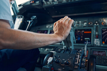 Experienced airline captain increasing the engine thrust - obrazy, fototapety, plakaty