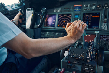 Fototapeta premium Aviator seated in the flight deck piloting an aircraft