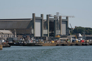Plymouth, Devon, England, UK. 2021. Royal Navy dockyard on the River Tamar, Plymouth, UK - Powered by Adobe