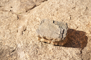 Stone podium on a beige background for a natural design concept. Central composition, top view. High quality photo