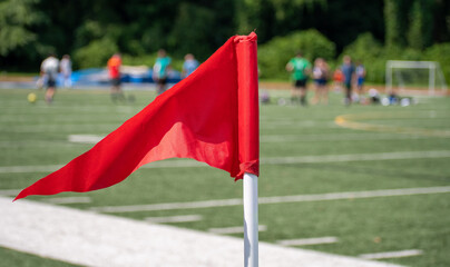 Red corner flag at recreational soccer game