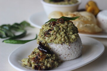 Steamed rice cake served with green gram curry and papad. A favorite dish of Kerala commonly known as puttu with payar and pappadam